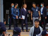 Lawrence Lau (centre) is leaving the court building after being acquitted, in Hong Kong, China, on May 30, 2024. (