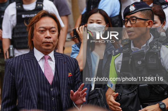 Lawrence Lau (left) is leaving the court building after being acquitted, in Hong Kong, China, on May 30, 2024. 