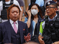 Lawrence Lau (left) is leaving the court building after being acquitted, in Hong Kong, China, on May 30, 2024. (