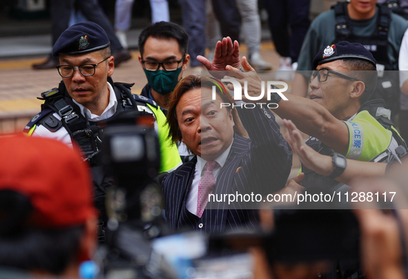 Lawrence Lau (centre) is leaving the court building after being acquitted, in Hong Kong, China, on May 30, 2024. 