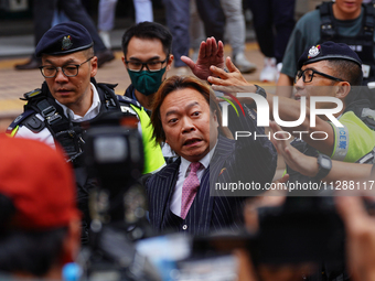 Lawrence Lau (centre) is leaving the court building after being acquitted, in Hong Kong, China, on May 30, 2024. (