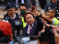 Lawrence Lau (centre) is leaving the court building after being acquitted, in Hong Kong, China, on May 30, 2024. (