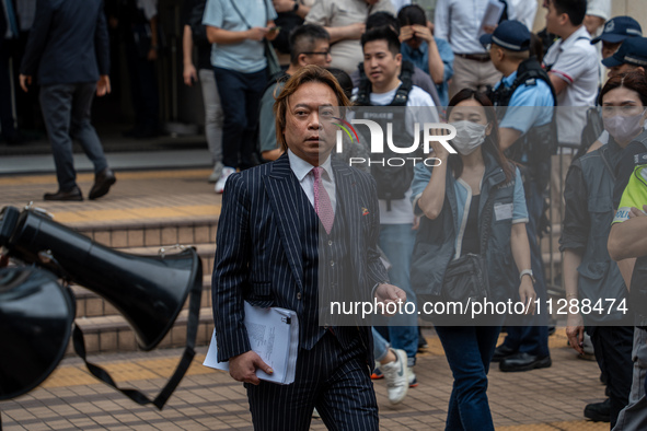 Lawrence Lau Wai-chung, one of the defendants who was acquitted in this case, is leaving the courthouse where the verdict of the trial of th...