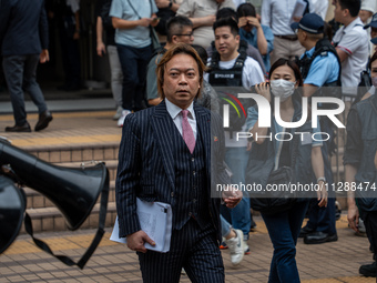 Lawrence Lau Wai-chung, one of the defendants who was acquitted in this case, is leaving the courthouse where the verdict of the trial of th...