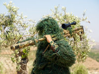 Military training exercises during the graduation ceremony of the Major General Mohammed Al-Faris course in Afrin countryside, northwest Syr...