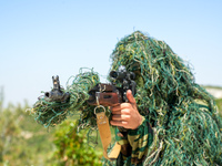 Military training exercises during the graduation ceremony of the Major General Mohammed Al-Faris course in Afrin countryside, northwest Syr...