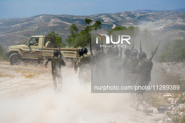 Military training exercises during the graduation ceremony of the Major General Mohammed Al-Faris course in Afrin countryside, northwest Syr...