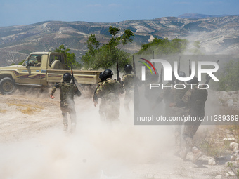 Military training exercises during the graduation ceremony of the Major General Mohammed Al-Faris course in Afrin countryside, northwest Syr...