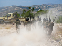 Military training exercises during the graduation ceremony of the Major General Mohammed Al-Faris course in Afrin countryside, northwest Syr...