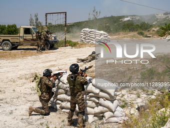 Military training exercises during the graduation ceremony of the Major General Mohammed Al-Faris course in Afrin countryside, northwest Syr...