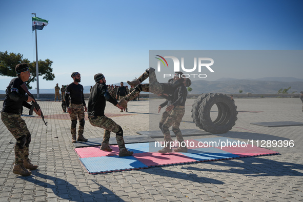 Military training exercises during the graduation ceremony of the Major General Mohammed Al-Faris course in Afrin countryside, northwest Syr...