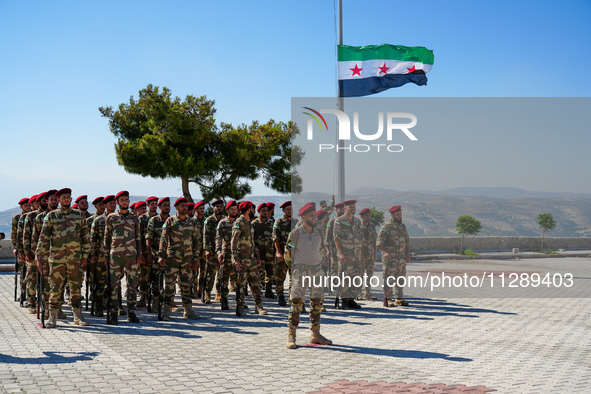 Military training exercises during the graduation ceremony of the Major General Mohammed Al-Faris course in Afrin countryside, northwest Syr...