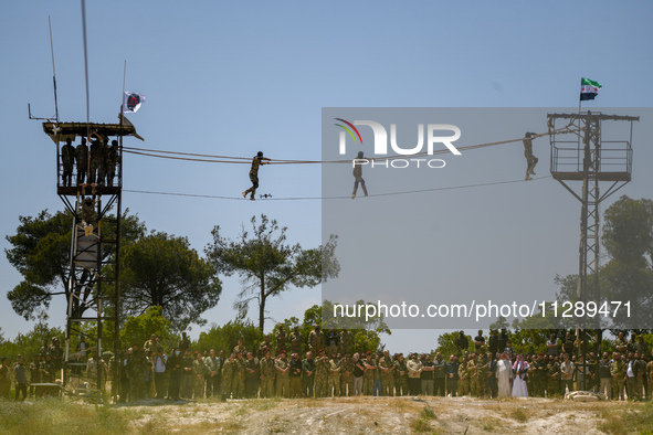 Military training exercises during the graduation ceremony of the Major General Mohammed Al-Faris course in Afrin countryside, northwest Syr...