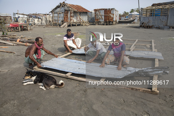 Men are repairing their damaged shop after Cyclone Remal's landfall in Patuakhali, Bangladesh, on May 29, 2024. Cyclone Remal, which made la...