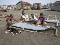 Men are repairing their damaged shop after Cyclone Remal's landfall in Patuakhali, Bangladesh, on May 29, 2024. Cyclone Remal, which made la...