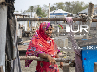 A woman is standing at a damaged shop after Cyclone Remal's landfall in Patuakhali, Bangladesh, on May 29, 2024. Cyclone Remal, which is mak...