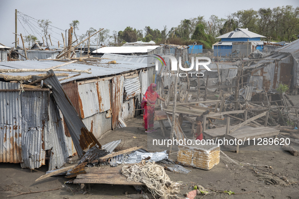 A woman and a child are standing at a damaged shop after Cyclone Remal's landfall in Patuakhali, Bangladesh, on May 29, 2024. Cyclone Remal,...