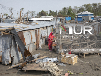 A woman and a child are standing at a damaged shop after Cyclone Remal's landfall in Patuakhali, Bangladesh, on May 29, 2024. Cyclone Remal,...