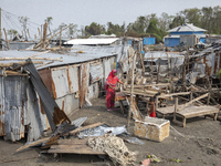 A woman and a child are standing at a damaged shop after Cyclone Remal's landfall in Patuakhali, Bangladesh, on May 29, 2024. Cyclone Remal,...