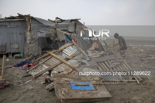 Men are repairing their damaged shop after Cyclone Remal's landfall in Patuakhali, Bangladesh, on May 29, 2024. Cyclone Remal, which made la...