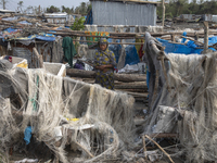 A woman is standing at a damaged house after Cyclone Remal's landfall in Patuakhali, Bangladesh, on May 29, 2024. Cyclone Remal, which is ma...