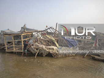 Men are repairing their damaged shop after Cyclone Remal's landfall in Patuakhali, Bangladesh, on May 29, 2024. Cyclone Remal, which made la...