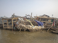 Men are repairing their damaged shop after Cyclone Remal's landfall in Patuakhali, Bangladesh, on May 29, 2024. Cyclone Remal, which made la...