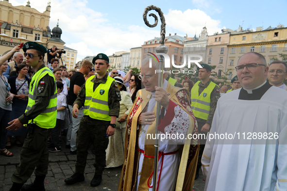 Metropolitan Archbishop of Krakow Marek Jedraszeski is walking through the city streets during the Corpus Christi procession in Krakow, Pola...