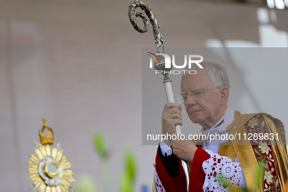 Metropolitan Archbishop of Krakow Marek Jedraszeski is walking through the city streets during the Corpus Christi procession in Krakow, Pola...