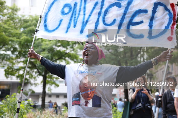 People are rejoicing across the street from Manhattan Criminal Court in New York, United States, on May 30, 2024, moments after a jury finds...