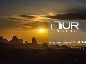 The Yadan landform landscape of the Devil City scenic area in the desert Gobi is being seen at sunset after strong winds in Karamay, China,...