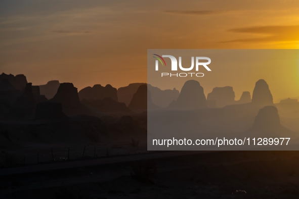 The Yadan landform landscape of the Devil City scenic area in the desert Gobi is being seen at sunset after strong winds in Karamay, China,...