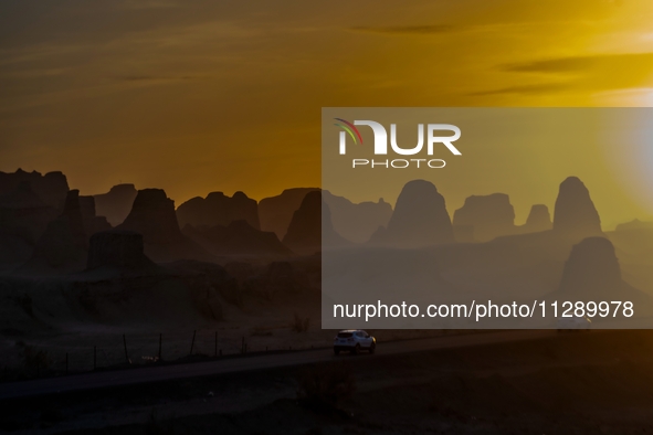 The Yadan landform landscape of the Devil City scenic area in the desert Gobi is being seen at sunset after strong winds in Karamay, China,...