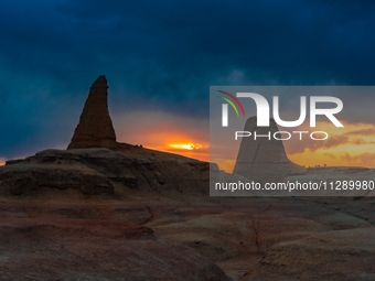 The Yadan landform landscape of the Devil City scenic area in the desert Gobi is being seen at sunset after strong winds in Karamay, China,...