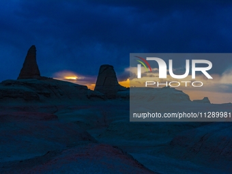 The Yadan landform landscape of the Devil City scenic area in the desert Gobi is being seen at sunset after strong winds in Karamay, China,...