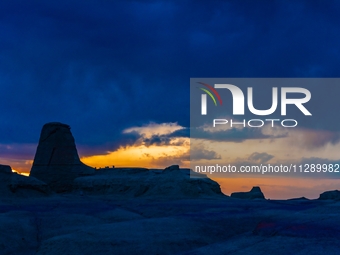 The Yadan landform landscape of the Devil City scenic area in the desert Gobi is being seen at sunset after strong winds in Karamay, China,...