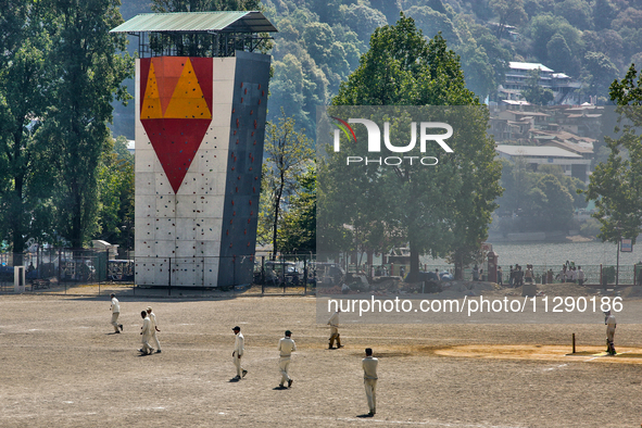 Men are playing a game of cricket in Nainital, Uttarakhand, India, on April 21, 2024. 