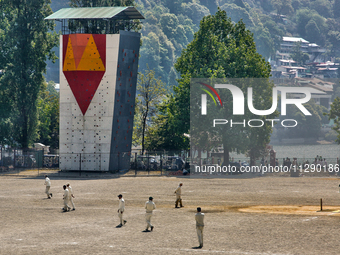 Men are playing a game of cricket in Nainital, Uttarakhand, India, on April 21, 2024. (