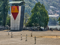 Men are playing a game of cricket in Nainital, Uttarakhand, India, on April 21, 2024. (