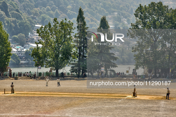 Men are playing a game of cricket in Nainital, Uttarakhand, India, on April 21, 2024. 