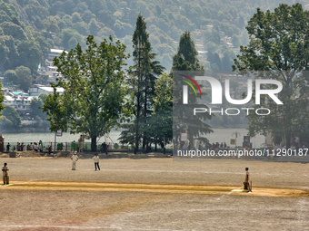 Men are playing a game of cricket in Nainital, Uttarakhand, India, on April 21, 2024. (