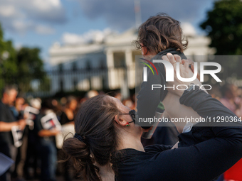 A woman holds a child at a 'Mourner's Kaddish for Rafah' demonstration in front of the White House in Washington, D.C. on May 30, 2024. The...