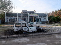 A burnt-out car is being seen outside a building damaged by the overnight Russian missile attack in the Novobavarskyi district of Kharkiv, n...