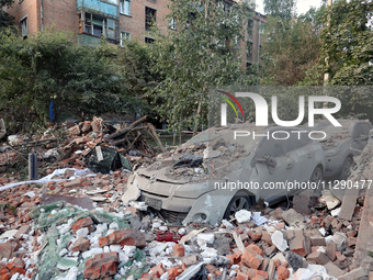 Cars are being crushed by the rubble outside a block of flats damaged by the overnight Russian missile attack in the Novobavarskyi district...