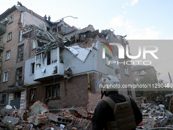 Rescuers are removing the rubble at a block of flats damaged by the overnight Russian missile attack in the Novobavarskyi district of Kharki...