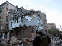 Rescuers are removing the rubble at a block of flats damaged by the overnight Russian missile attack in the Novobavarskyi district of Kharki...