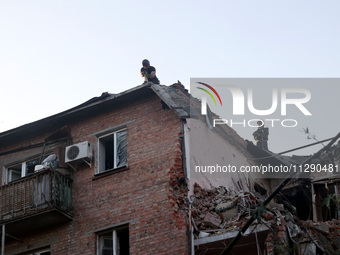 Rescuers are removing the rubble at a block of flats damaged by the overnight Russian missile attack in the Novobavarskyi district of Kharki...