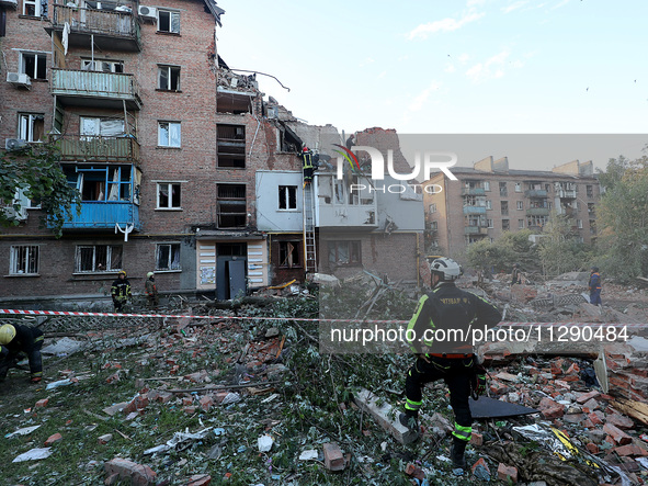 Rescuers are removing the rubble at a block of flats damaged by the overnight Russian missile attack in the Novobavarskyi district of Kharki...