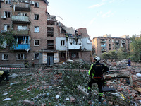 Rescuers are removing the rubble at a block of flats damaged by the overnight Russian missile attack in the Novobavarskyi district of Kharki...