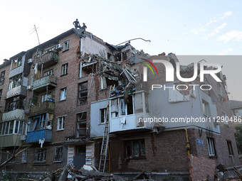 Rescuers are removing the rubble at a block of flats damaged by the overnight Russian missile attack in the Novobavarskyi district of Kharki...